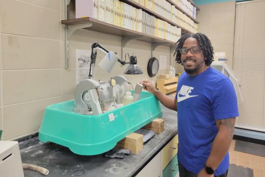 Naeem Willett processing a red snapper otolith at the Panama City laboratory.